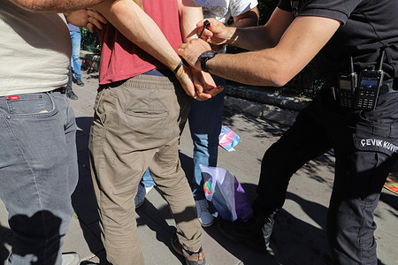Police officers in plain clothes arrest rowdy protesters during the Pride rally. Police Officers intervene among protesters who were gathered for the Pride Week celebrations in Ankara. The LGBTI+ protesters wanted to gather and march in Kuğulu Park, Ankara, but were banned by Police. The protesters became violent and the Police detained many of them.