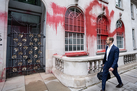 A man walks past the headquarters of INVESCO that has been splattered with red paint by Palestine Action. Palestine Action attacked the headquarters of INVESCO in its ongoing campaign targeting companies involved with the arming of Israel. The campaign group is due to be proscribed by the UK government for its arson and vandalism activities.