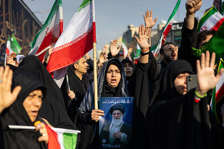A woman seen holding a poster of Ayatollah Ali Khamenei, the former Supreme Leader of Iran who was killed during the Iran–Israel and U.S. war. Thousands of supporters gathered at Enghelab Square in Tehran to pledge allegiance to Mojtaba Khamenei after he was named Iran’s third Supreme Leader. The announcement was made by the Assembly of Experts following the death of his father, Ali Khamenei, in U.S.–Israeli airstrikes on Feb. 28. Participants waved Iranian flags and chanted slogans against the United States and Israel.