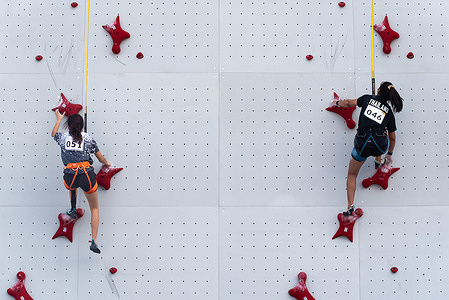 Jeanette Frances Koh (L) from Singapore and Jiraporn Kaitwatcharachai (R) from Thailand compete during the Women's speed climbing in 33rd SEA Games at Bangkok Sport Climbing Center.