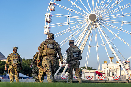 National Guard patrol the grounds of the Great American State Fair on the National Mall, Thursday, July 2, 2026, in Washington. Temperatures reach a record setting 102º in Washington during the Great American State Fair.