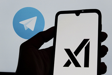 In this photo illustration, the XAI logo is seen displayed on a smartphone with the Telegram logo in the background.