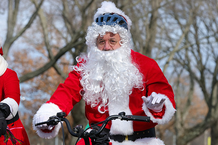 A man dressed as Santa Claus rides a bicycle during the second annual Cycling Santa bike ride.