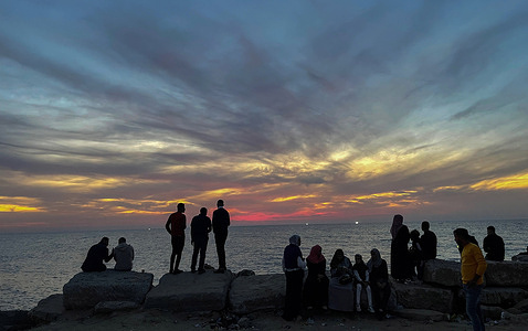 Palestinians enjoy the sunset at the Gaza seaport in the west of the city.