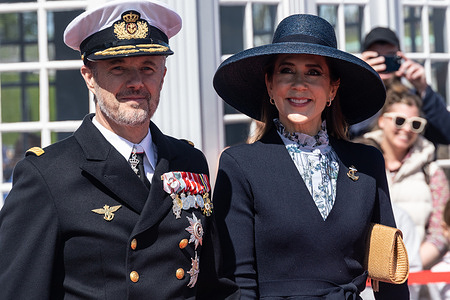 King Frederik (L) and Queen Mary (R) arrive as they officially board the Royal Yacht Dannebrog from Nordre Toldbod in Copenhagen. This is a yearly event, the traditional tour to nearby Helsingør, and marks the beginning of the Royal sailing season, which this year takes them around Denmark and to the Faroe Islands.