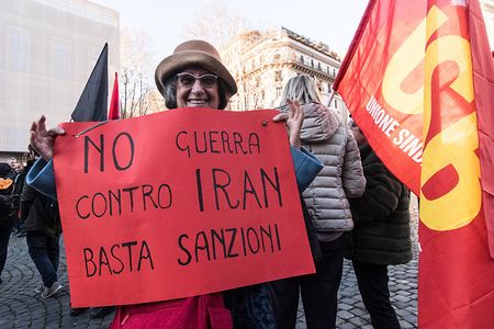 Demonstrator holding a placard during the protest.
At Piazza Barberini a protest was held for Peace and against the risk of an escalation of war between the US and Iran, determined by the targeted assassination of the Iranian Major General Qasem Soleimani killed by US drone strike - ordered by the US President Donald Trump and the consequent Iranian missile launch against two US bases in Iraq. Protesters called the Italian Government to withdraw the Italian troops from Iraq and from all other war scenarios, to leave NATO, and for a drastic reductions of the military expenses.
