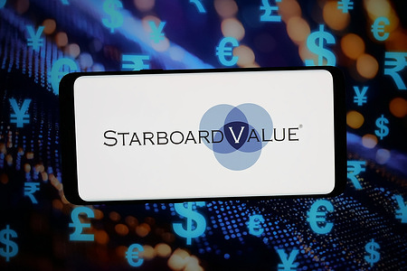 In this photo illustration, the logo of US investment company Starboard Value LP is seen displayed on a smartphone in front of an abstract background on a computer screen.