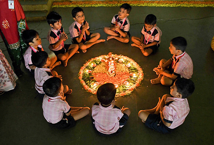 Students of Shivaji Shikshan Sanstha school offer prayers after lighting the earthen lamps on the occasion of 'Ashadh Amavasya' in Mumbai. Ashadha Amavasya falls on the new moon day during the Hindu month of Ashadha every year during June or July. Students light earthen lamps and offer prayers for improving concentration, positivity, peace, prosperity, brotherhood, and enlightenment.