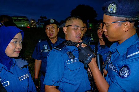 Royal Malaysian Customs officers checks their uniform during a final day rehearsal for the Malaysian 68th Independence celebration. The Malaysian 68th Independence day celebration full rehearsal on 29th August 2025 in Putrajaya, Kuala Lumpur.