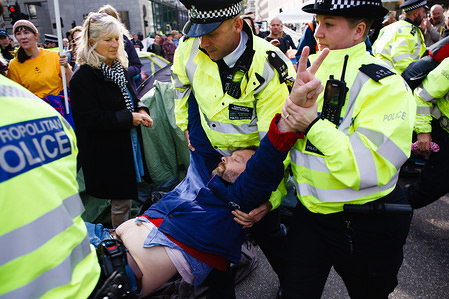 Police officers arrest a member of climate change activist movement, Extinction Rebellion (XR) refusing to move on from an encampment on Victoria Street during the third day of the group's 'International Rebellion' in London.
Police officers continue to clear demonstrators and tents from sites across Westminster, with activists having been warned about moving to a designated protest area around Nelson's Column in Trafalgar Square or face arrest. Similar blockades by Extinction Rebellion in April, at sites including Oxford Circus and Waterloo Bridge, saw more than 1,000 arrested, a tactic promoted by XR founder Roger Hallam as a means of maximising disruption and publicity. Besides London, demonstrations are being staged by XR chapters in dozens of cities around the world.