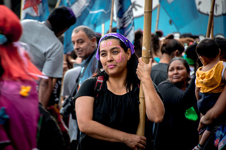 Leaning against a bamboo support pole, a protestor carries a banner down Avenida de Mayo. Marching from the nation's iconic Congreso buildings to Plaza De Mayo, these women are protesting violence against women during the country's 3rd annual Ni Una Menos march.
The Ni Una Menos movement (loosely: "Not one [woman] less") is an Argentine feminist cause, started in 2015 that has since spread to multiple Latin American countries. Protests are often held to help bring attention to femicide, but also address topics such as gender roles, sexual harassment, sexual objectification, legality of abortion, sex workers' rights, and transgender rights.