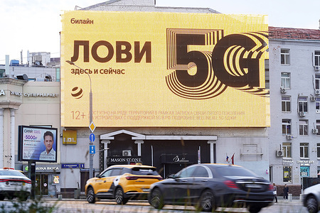 A large digital LED billboard showcasing a bright yellow 5G internet advertisement by the Russian mobile network provider Beeline is seen at Taganskaya Square .