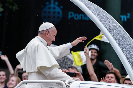 Pope Francis waves to joyful crowds from the pope mobile as he makes his way through the streets during World Youth Day 2016. Thousands of pilgrims line the historic city center holding flags and chanting songs of faith and capturing a once-in-a-lifetime moment. The Holy Father's presence brings a palpable sense of unity, hope and celebration to a city transformed by the spirit of young believers from all over the world. Cardinal Dziwisz, a key figure in the organization of the event stands as a symbol of the Polish Church’s deep connection to youth and tradition.