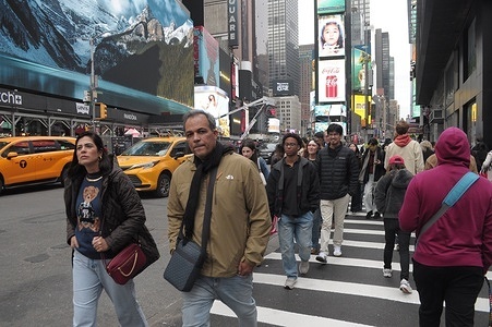 People walk in Times Square, Manhattan, New York City.