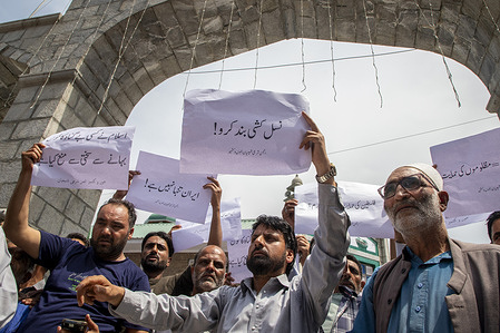 Kashmiri Shiite Muslims hold placards as they chant Pro-Iranian and Anti-Israel slogans during a protest south-west of the capital city, Srinagar. Israel launched aerial strikes hitting around 100 targets across Iran including nuclear facilities, military command centers and residential areas killing senior figures such as the chief of the armed forces, top nuclear scientists and civilians according to Iranian state media.