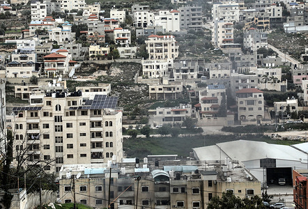 Smoke rises from among the Palestinian homes in the Nur Shams refugee camp, which has been besieged by Israeli forces for 317 days, east of Tulkarm in the northern West Bank. Israeli military bulldozers are demolishing Palestinian homes to widen roads, displacing approximately 100 Palestinian families. The military operations in the Nur Shams camp have been ongoing for 317 days.