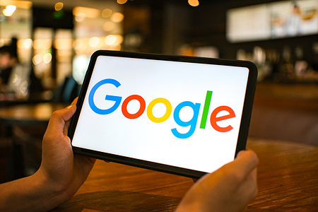 In this photo illustration, the Google logo is seen displayed on a tablet screen.