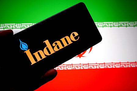 In this photo illustration, an Indane logo is seen displayed on a smartphone with the Iranian flag in the background.