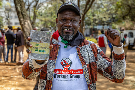 Kenyan human rights activist Happy Olal speaks to the media while holding a copy of the Constitution of Kenya during a gathering at Jeevanjee Gardens in Nairobi to mark 16 years since the promulgation of Kenya’s 2010 Constitution. Activists, Bunge la Mwananchi representatives, presidential aspirants and former Chief Justice Willy Mutunga gathered to mark 16 years since the promulgation of Kenya’s 2010 Constitution and discuss the implementation of the constitution, human rights and accountability.