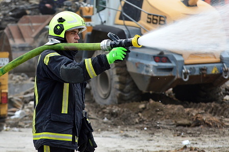 A firefighter uses water to extinguish a fire at the site of explosions in buildings after a nighttime Russian attack. On the night of June 6, Russian forces launched a combined attack on Kyiv and the capital region using ballistic missiles and drones.