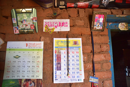 The wall inside Bharati's home filled with calendars and pictures.
Women spend a lot of time fetching water getting little time to do other things because there are very few wells across the region and most of them go dry during the summer. It’s a long term problem and no one has come up with a solution yet.