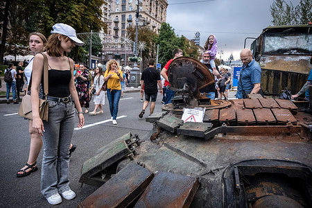 People observe a display of a Russian tank turret in Kyiv, Ukraine. As dedicated to the upcoming Independence Day of Ukraine, and nearly 6 months after the full-scale invasion of Ukraine on February 24, the country's capital Kyiv holds an exhibition on the main street of Khreschaytk Street showing multiple destroyed military equipment, tanks, and weapons from The Armed Forces of The Russian Federation (AFRF). As the Russian full invasion of Ukraine started on February 24, the war has killed numerous civilians and soldiers, nearly 9000 Ukrainian military personnel have been killed in the war with Russia, the head of Ukraine's armed forces said on Monday, August 22, 2022.