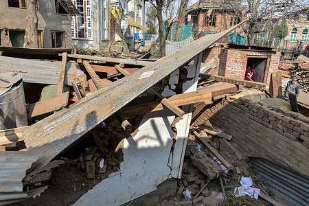 Residents stand near a debris of blown-up house of Dr Umar Nabi, a prime accused in the Red Fort car bombing, that killed 13 people on November 10, in New Delhi. Security agencies blew up the house of Dr Umar Nabi, who as per investigators orchestrated a car bombing in New Delhi, that killed 13 people and injured dozens.