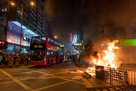 Traffic swerves around the large bonfire set in the middle of the street during the demonstration. 
Protesters rallied in front of the Prince Edward Station, denouncing the actions taken by police on August 31 and demanding the release of the CCTV footage from that date. Protesters heckled and used laser pens on police, but were soon forced to retreat during a dispersal operation. Despite the withdrawal of the extradition bill, protesters are unsatisfied, now demanding the remaining four 'key demands' from the government.