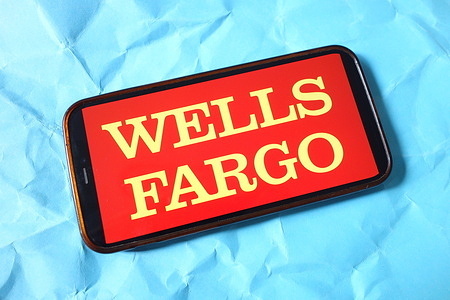 In this photo illustration, the Wells Fargo company logo is seen displayed on a smartphone screen.