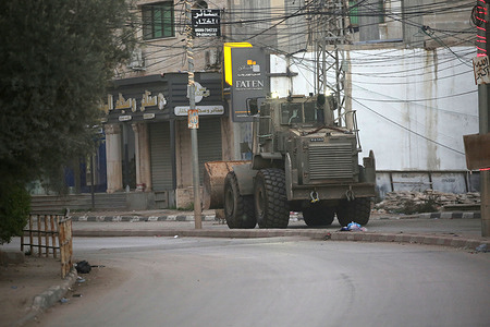 Israeli military reinforcements arriving in the town of Qabatiya, south of Jenin in the northern West Bank. The Israeli army announced it was conducting operations in several locations in the West Bank following a Palestinian attack that killed an Israeli woman and wounded four others in the southern Israeli city of Beit She'an. The Israeli army raided the home of the Palestinian attacker in Qabatiya, and the Israeli Defense Minister ordered the army to carry out a large-scale operation and impose a siege on the town.