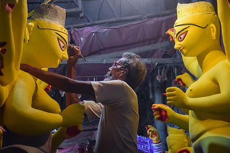 An artist gives his final touch on a Durga idols. 
Durga puja is one of the most popular festivals celebrated in West Bengal and particularly in Kolkata, In honour of Goddess Durga the period of Navaratri. It is celebrated for 10 days, however starting on the 6th and 9th day, the Puja is celebrated in full phase.