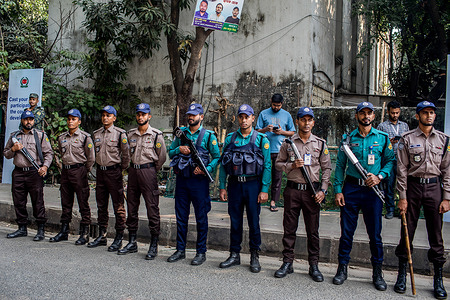 Bangladesh police officers stand on guard during a mock voting exercise at Sher-e-Bangla Nagar Government Girls High School. The Election Commission conducted a mock voting exercise from 8:00 a.m. to 12:00 p.m. for both the upcoming national election and referendum, which are likely to be held simultaneously on a single day in early February 2026.