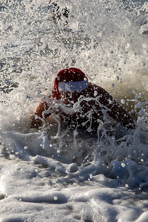 A swimmer seen during the traditional Christmas Day swim at Brighton Beach. Members of the public took part in the annual Christmas Day swim held at Brighton Beach, East Sussex, England. Originally established by the Brighton Swimming Club in 1860, this event is regarded as one of the oldest festive swims in England. On the morning of Christmas Eve, swimmers arrived with some dressed in festive seasonal outfits to enter the water at 11:00 a.m.