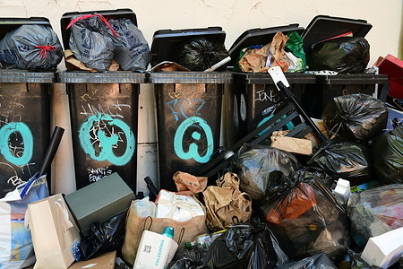 Several bags and trash cans in the city of Lyon.