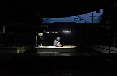 A lone saleswoman in a Kyiv bazaar packs up her belongings to go home after selling out her merchandise during a blackout. As a result of massive missile attacks on Ukraine's electric power infrastructure by Russia, more than 50% of the country's unified energy system was lost, National Energy Company (NPC) Ukrenergo said.