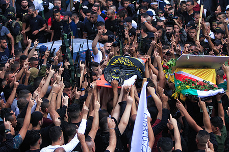 (EDITORS NOTE: Image depicts death) 
Mourners and gunmen carry the body of 18-year-old Palestinian gunman Matin Dabbaya, who was killed during clashes with the Israeli army in the Jenin refugee camp near the city of Jenin in the occupied West Bank. The Israeli army stormed the Jenin refugee camp to arrest a wanted man. The Palestinian Ministry of Health said that a Palestinian was killed and 14 others, including a doctor, were wounded during this military operation.