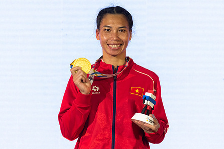 Ha Thi Linh of Vietnam poses for a photo after winning a gold medal for the Women's 60 kg. Boxing finals in 33rd SEA Games at CU Sports Complex.