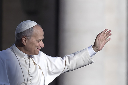 Pope Leo XIV waves as he arrives for his weekly general audience in St. Peter's square at the Vatican.
