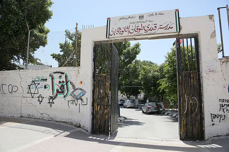 A Palestinian school entrance seen painted with the Hebrew graffiti and an Israeli Star of David painted on the wall in the West Bank city of Nablus. The graffiti was painted by a group of religious Jewish settlers attending Talmudic prayers at Joseph's Tomb in Nablus.