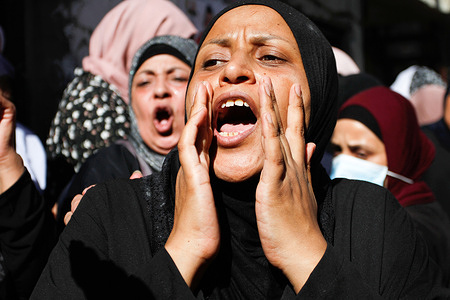 A relative crying during the funeral of 15-year-old Palestinian, Imad Hashash, who was killed in clashes with Israeli forces.