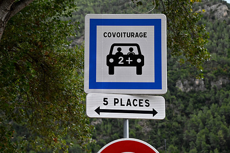 Signs indicating parking spaces reserved for people practicing carpooling, seen at a carpooling area in Nice. Carpooling area in Nice, France.