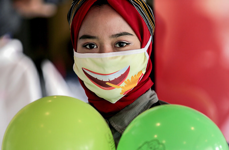A woman looks on while wearing a face mask at a Mcdonald's Sarinah.McDonald's Sarinah fast food restaurant in Central Jakarta is officially closed today. The company was asked to evacuate the building by the owner (PT Sarinah (Persero), because the entire building will be renovated.