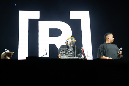 A masked DJ and hip-hop vocalist take the stage during the opening acts at Residente’s concert, joining a musical dialogue between urban beats and traditional huapango. Puerto Rican rapper René Pérez Joglar, known professionally as Residente performed a free outdoor concert at Glorieta Independencia as part of Festival de Octubre in Tijuana, Mexico, gathering more than 50,000 people in a celebration of music, identity, and community.