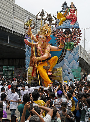 A view of an idol of an elephant-headed Hindu god Ganesha as its carried from the workshop to pandal (temporary shelter). The ten day festival of Ganesh Chaturthi will begin from 14th September till 25th September and will be celebrated across the country.