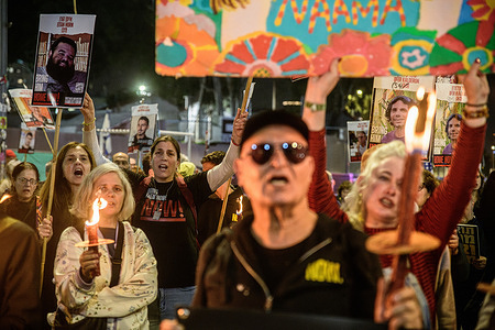 Israelis hold up torches and signs with posters of the Israeli hostages during the demonstration. Israelis gathered in front of the Israel Defense Force headquarters in Tel Aviv on the 467th day of the war, calling for a full hostage deal and ceasefire. The demonstration coincided with a humanitarian phase of the Israeli-Hamas hostage agreement, which included the release of over 30 hostages kidnapped on October 7th from Gaza.
