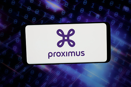 In this photo illustration, the logo of Belgian telecommunications company Proximus is displayed on a smartphone in front of abstract background on computer screen.
