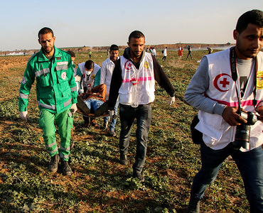Medics seen carrying an injured protester during the clashes.
Palestinian citizens and the Israeli forces clashed north of the Gaza Strip in the area of Abu Safiya in protest against the recognition of US President Trump Jerusalem as the capital of Israel and refused the blockade.