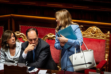 Italian Prime Minister Giorgia Meloni (R) leaves after the speech to brief the Italian Senate ahead of the next European Council meeting at Palazzo Madama.