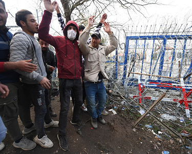 Demonstrators shout and wave their arms at the Pazakule border crossing.
Thousands of refugees are still stuck at the Pazakule border crossing close to Edrine, Turkey. They wait in the belief that the Greek / Turkish border will soon re-open and allow them access to Europe. Although the rioting situation is now calmer the demonstrations still continue. The aid agencies are feeding thousands of refugees and the Erdine town council is doing everything they can to support the aid effort.