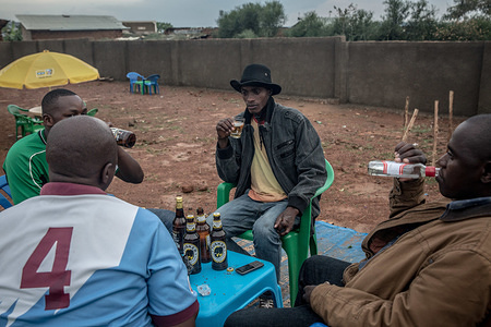 Men seen drinking beer at a bar in Nakivale refugee settlement south west Uganda.
Nakivale was established in 1958 and officially recognized as a refugee settlement in 1960. The settlement hosts more than 100,000 refugees from Burundi, the Democratic Republic of Congo, Eritrea, Ethiopia, Rwanda, Somalia, Sudan, and South Sudan.